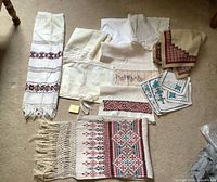 Full lot view showing variety of embroidered linens laid out