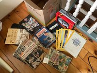 Group shot of all magazines and books spread on floor next to box