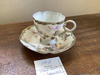 Tea cup on saucer side view showing pattern and shape