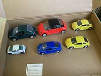 Six Volkswagen Beetle model cars in box