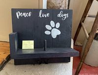 Front view showing text, paw print, shelf, peg and hooks