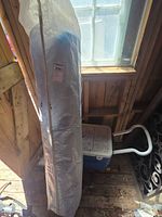 Coleman wheeled cooler and rolled tarp in carry bag