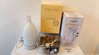 Full lot showing boxed Homedics diffuser, loose ceramic diffuser, Gratiae kit, oils