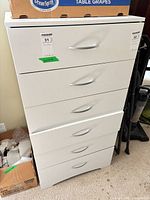 Front view of white six-drawer dresser with metal handles