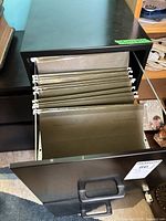 Cabinet with bottom drawer open showing hanging folders