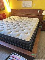 Full view of wooden king bed frame with mattress in place