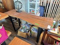 Full view of console table showing live edge wood top and metal base