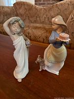 Both figurines side by side on table