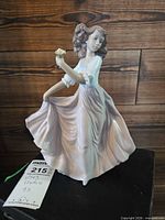 Front view of Lladro Summer Breeze figurine showing girl holding flowers