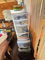 Stacked 4-drawer and 3-drawer plastic cabinets with contents, computer bag visible