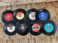 Group shot of all eight 7-inch records showing label variety