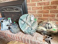 Group of decorative pottery plates, metal décor piece, small pottery sculpture