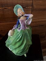 Front view of the Royal Doulton Autumn Breezes figurine showing overall appearance and paint details