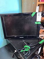 Front view of Samsung 19-inch monitor with attached cords and wall mount