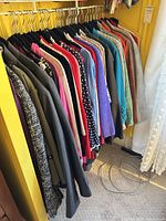 Rack of assorted jackets and sweaters on hangers