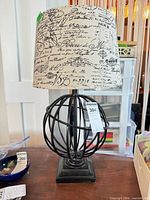 Full view of lamp with globe base and printed shade