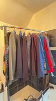 Row of assorted women’s jackets on hang rod