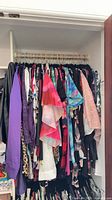 Full closet rack showing quantity and variety of plus-size tops and sweaters