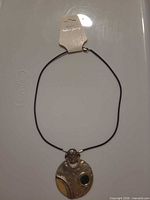 Full necklace laid flat showing pendant and cord