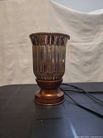 Amber fluted glass electric wax warmer with power cord visible