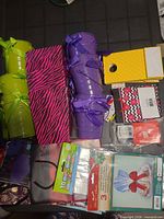 Assorted gift-wrapping supplies including metal pails, treat boxes, gift bags, cellophane bags and tags