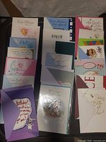 All 20 cards arranged in four columns showing designs and envelopes
