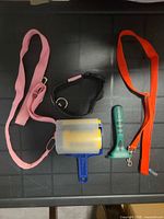 All items laid out: two leashes, collar, lint roller, Furminator brush