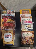 Two stacks of assorted cookbooks showing covers and formats