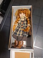 Doll in original box with stand visible at side