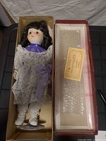 Doll inside original box with stand and COA