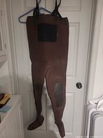 Front view of brown neoprene hip waders showing chest pocket, suspenders and knee reinforcement