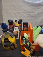 Full lot showing bottles, aerosols, brushes, mitts, caddy