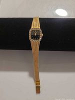Full view of watch showing gold mesh bracelet and case