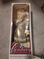 Boxed Century Collection porcelain doll, full front view