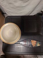 Overview of one ceramic bowl, fish grill basket and square grill basket