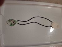 full view of necklace showing pendant design and cord length