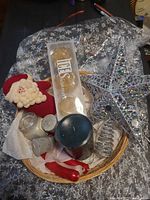 Overview of basket showing candles, ornaments, cellophane wrap