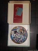 Plate in foam insert with booklet and certificate inside original box