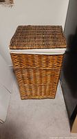 Closed rectangular wicker hamper showing exterior and lid