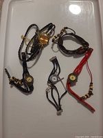 All five wrap style watches laid out showing variety of colours and designs