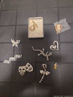 Overview of all ten brooches and display box