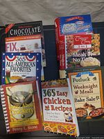 All eight cookbooks arrayed on table