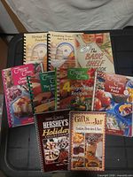 All nine spiral cookbooks laid out front covers visible