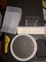 All items arranged: lazy Susan, bins, citrus press, acrylic holder, tray, sink protector