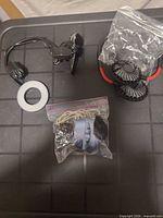 Assorted accessories including neck fan parts, replacement pads and clip mount on tray