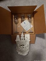 Box containing three glass votive holders and separate Village Carolers candle holder