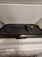 Front view of black Chef rectangular electric grill with detachable temperature probe