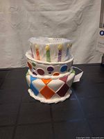 Front view of Scentsy ceramic cake-shaped warmer in plastic wrap