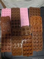top view showing all fifteen silicone molds in two colour groups with various cavity shapes
