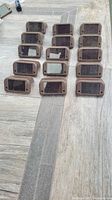 Fifteen brown solar lights face up showing solar panels